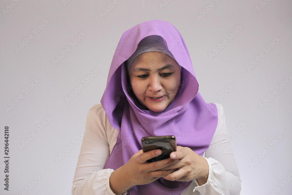 Muslim Woman Angry While Reading Text Message on Smart Phone Muslim Woman Angry While Reading Text Message on Smart Phone