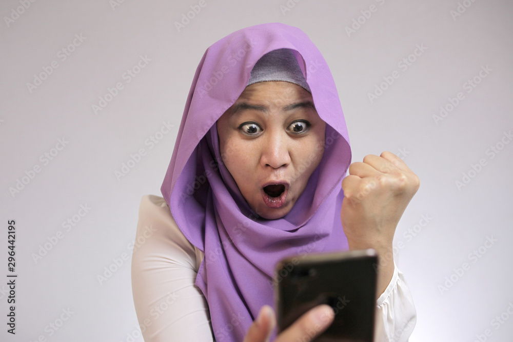 Young Muslim Woman Get Good News on Her Phone Young Muslim Woman Get Good News on Her Phone