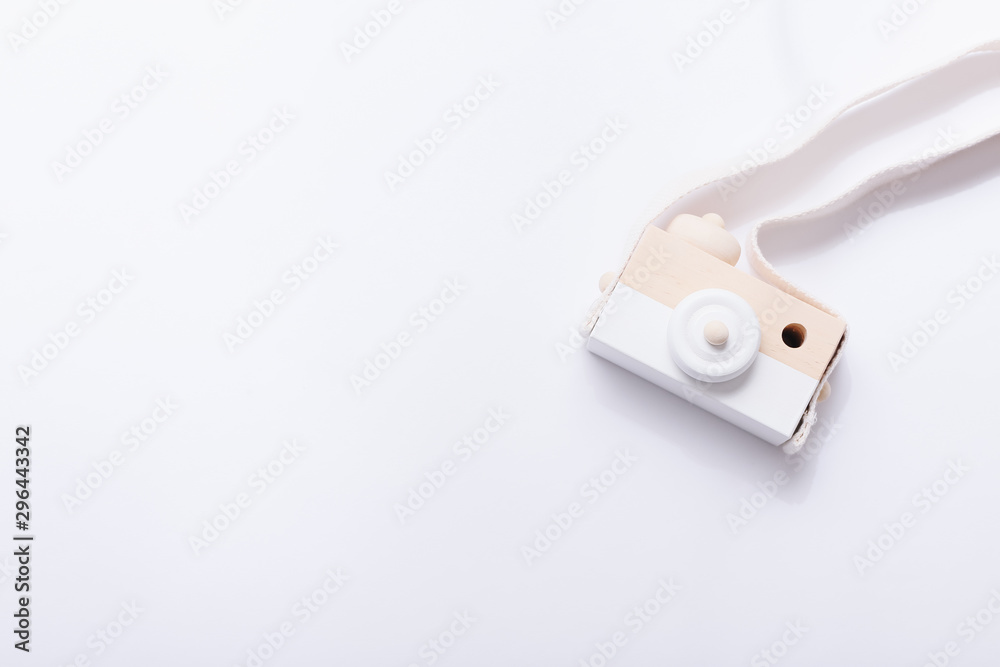Wooden nordic camera toy for babies on white background, top view Wooden nordic camera toy for babies on white background, top view