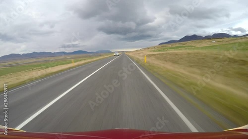 POV driving past police car under storm clouds Icelandic countryside.mov photo