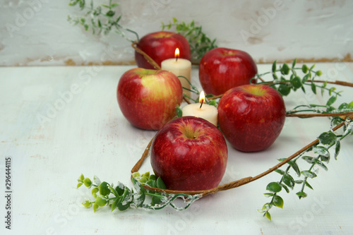 Red apples with candles and leaves.