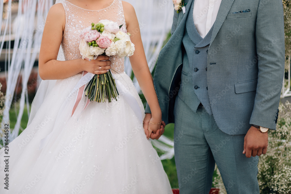 Wedding ceremony. Bride and groom holding hands close up Wedding ceremony. Bride and groom holding hands close up