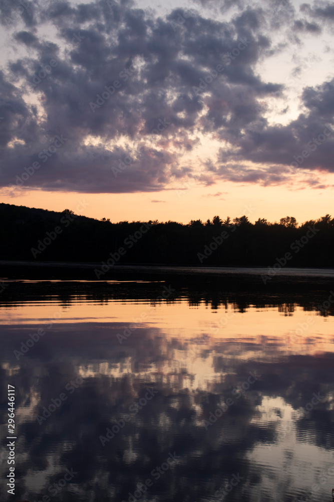 Sunset on The Lake in Vermont. Beautiful nature retreat. Sunset reflected in the water. Calming and relaxing escape.