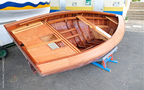 Hull of a newly built small classic wooden racing boat.