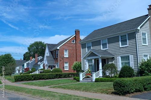 Suburban street with older brick and clapboard houses photo