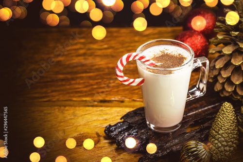 Eggnog. Typical Christmas drink with Christmas lights background. Bokeh effect in Christmas theme. Winter drink fifty.