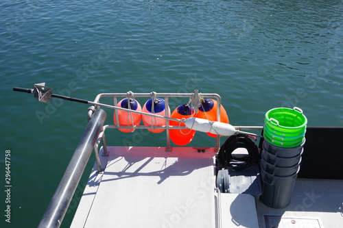 Four red buoys and other equipment on a commercial fishing boat in the harbor
