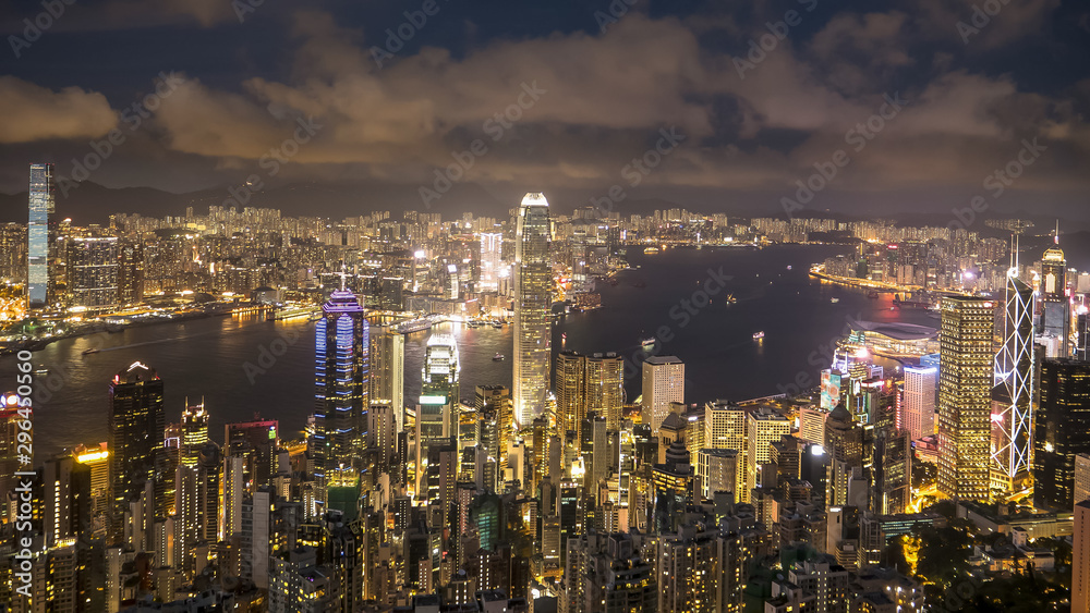 night shot of victoria harbor from the peak in hong kong