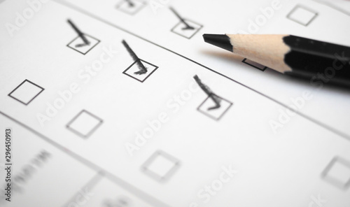 Black marking on checklist box with pencil close up. Checklist concept photo