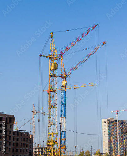 Several tower cranes are active. Construction and industrial development