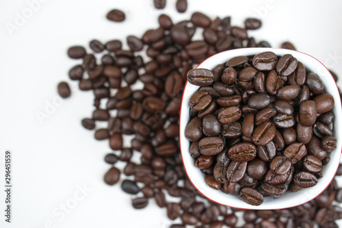 Fototapeta Naklejka Na Ścianę i Meble -  Close-up texture of coffee beans in a glass on a white background