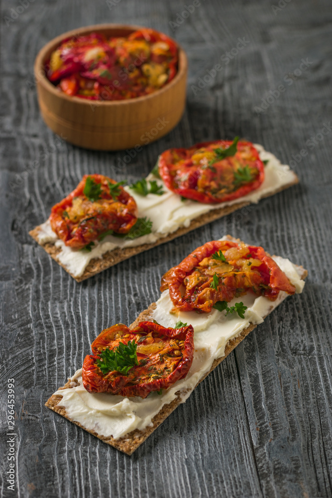 Two toasted toast with cream cheese and sun-dried tomatoes. Two toasted toast with cream cheese and sun-dried tomatoes.