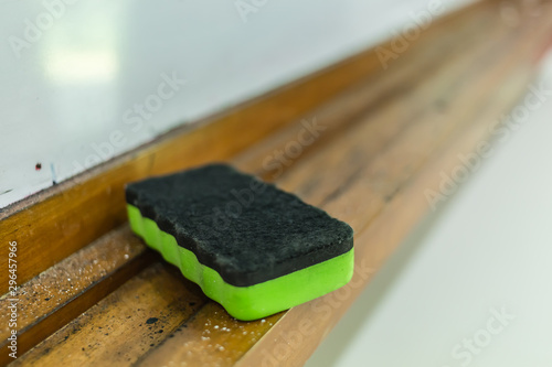 plastic green color whiteboard eraser closeup detail view