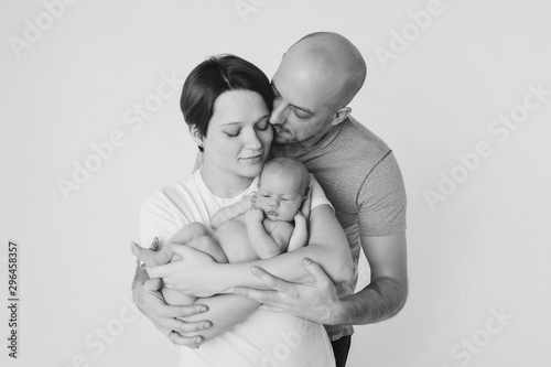 family photo on a white background: parents spend time with their children. mom and dad hug the baby. the concept of childhood, fatherhood, motherhood, IVF