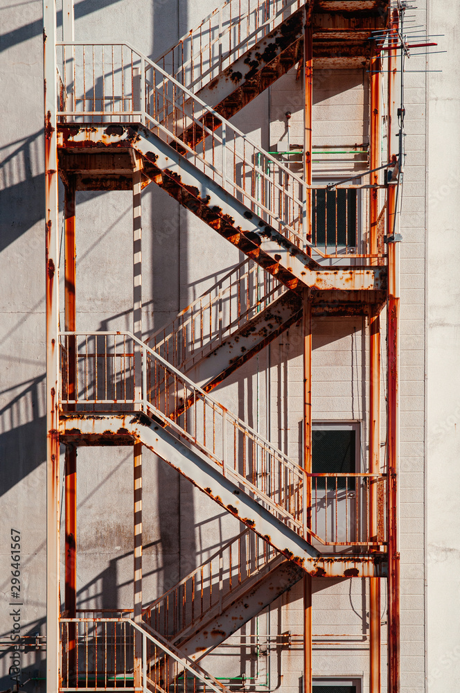 Fototapeta premium Old rusty building Emergency Fire Escape with metal iron stairway
