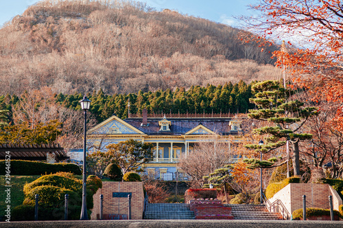 Old Hakodate Public Hall European style building in Motomachi with Mount Hakodate in background in autumn photo
