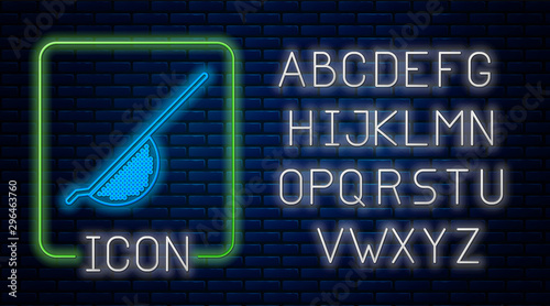 Glowing neon Kitchen colander icon isolated on brick wall background. Cooking utensil. Cutlery sign. Neon light alphabet. Vector Illustration
