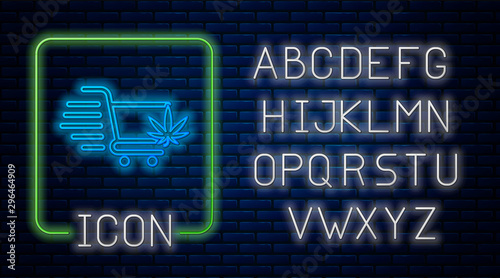 Glowing neon Shopping cart with marijuana or cannabis leaf icon isolated on brick wall background. Online buying. Delivery service. Supermarket basket. Neon light alphabet. Vector Illustration