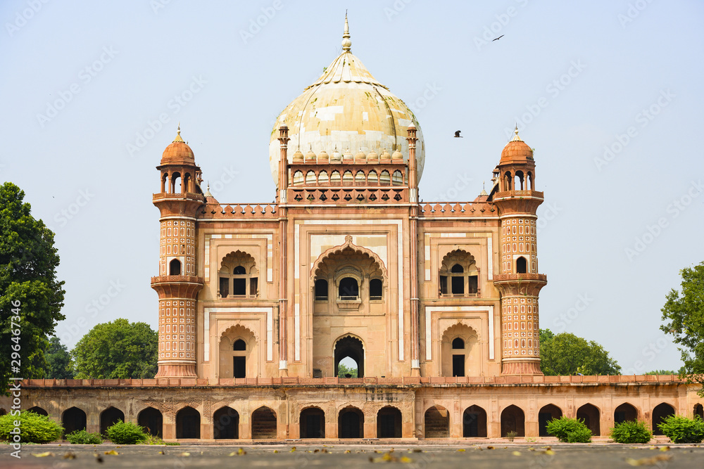 Stunning view of the Safdarjung Tomb with its domed and arched red brown and white coloured structures. Safdarjing is a sandstone and marble mausoleum in New Delhi, India.