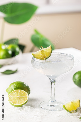 Refreshing Homemade Classic Alcoholic Margarita Cocktail with Lime and Salt on light background