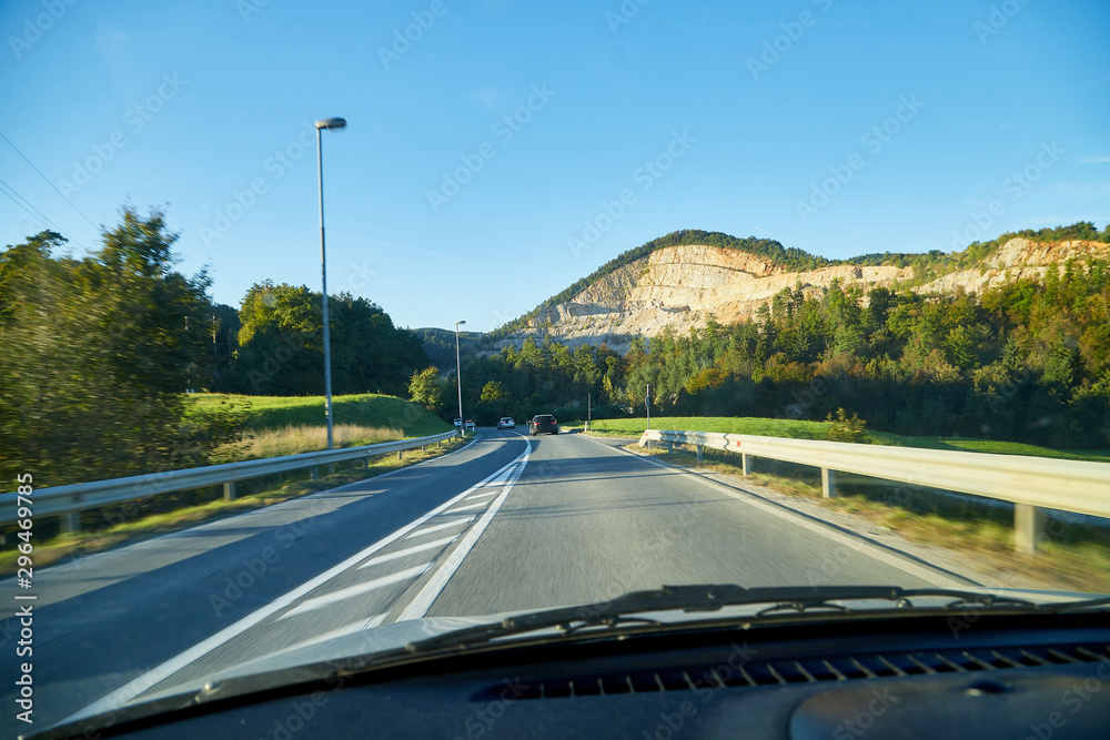View of the road with a beautiful mountain landscape from the car window View of the road with a beautiful mountain landscape from the car window