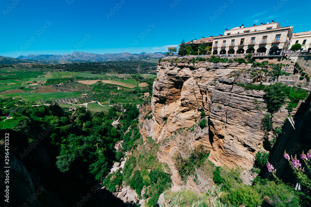 Beautiful landscape with blue sky and view of the rock with an old palace complex located on top and greenery at the foot of the mountain