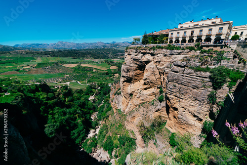 Beautiful landscape with blue sky and view of the rock with an old palace complex located on top and greenery at the foot of the mountain