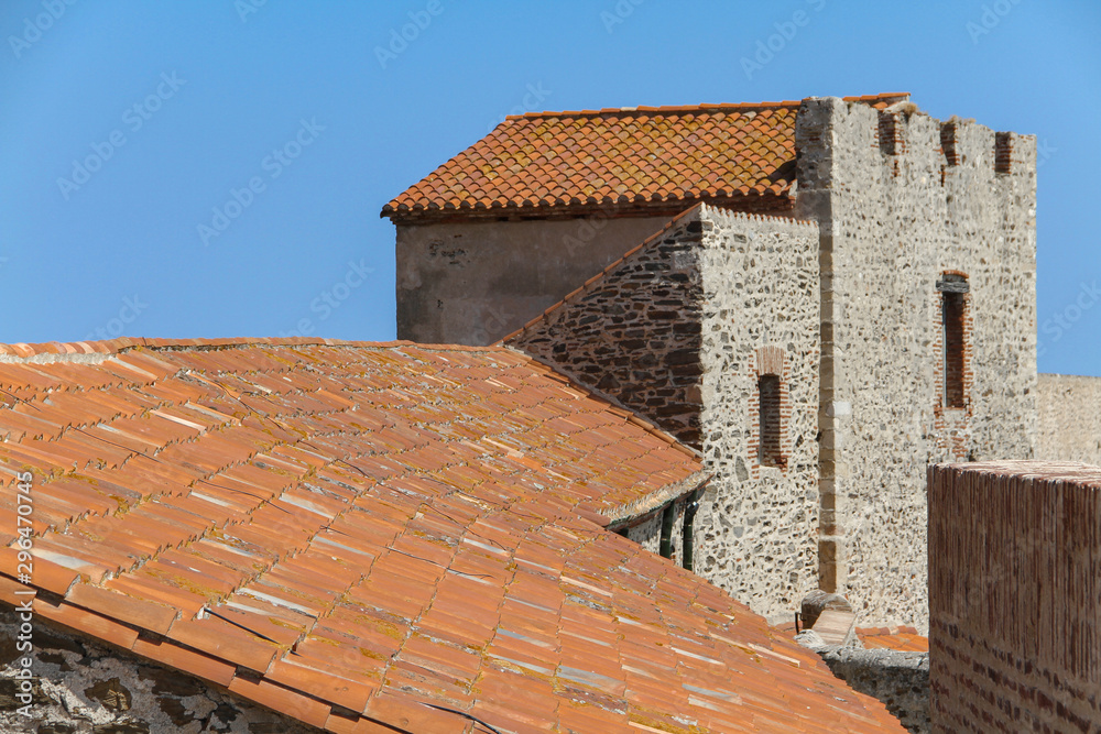Tile roofs and stone walls of an old knight's castle in France