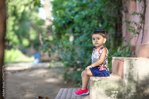 cute indian baby girl playing in the park