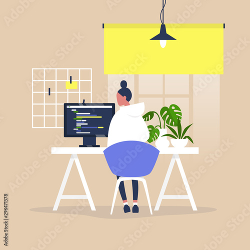Tech industry, Young female male web developer writing a code on a desktop computer in a modern office