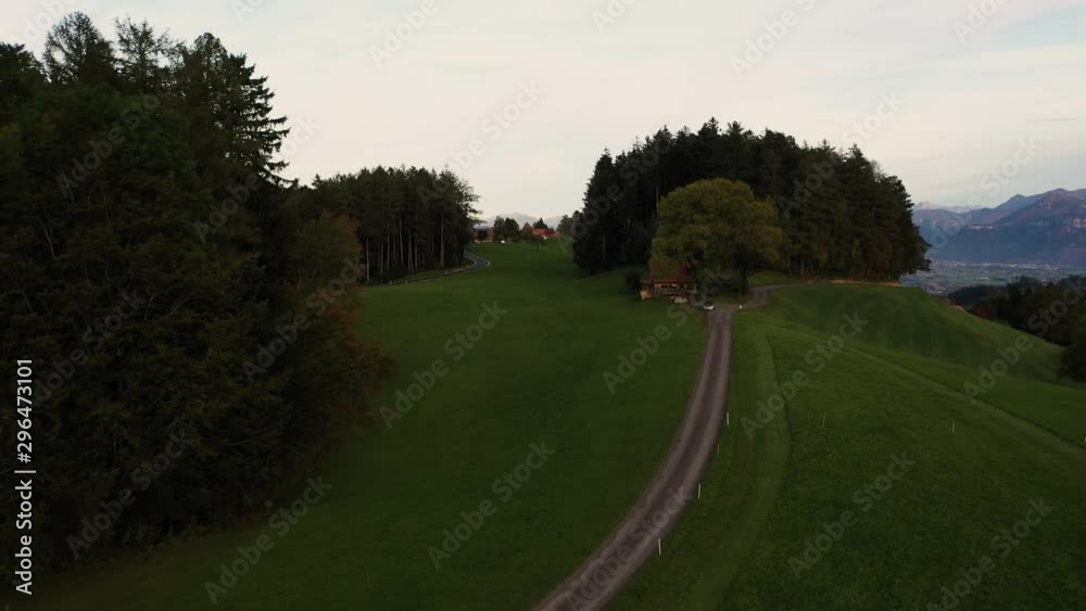 Drone flight in the evening on golden hour in beautiful Switzerland, showing the nature and village and hills and mountains of Switzerland. Drone flight in the evening on golden hour in beautiful Switzerland, showing the nature and village and hills and mountains of Switzerland.