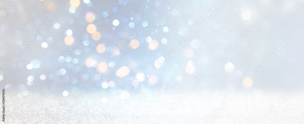 Obraz premium abstract glitter silver, gold , blue lights background. de-focused. banner