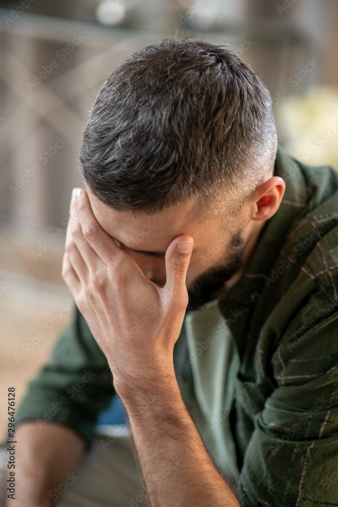 Man having headache while waiting for psychoanalyst Man having headache while waiting for psychoanalyst