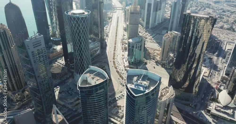 Epic top-down aerial view of Doha, highly developped global city of the future, with high rise buildings and skyscrapers, in Qatar