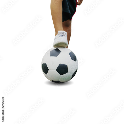 The boy in sportswear wearing sneakers is stepping on a soccer ball isolated on white background, with clipping path.