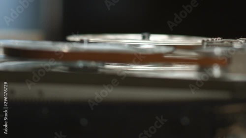 Running tape on reel in old vintage tape recorder rack focus close up