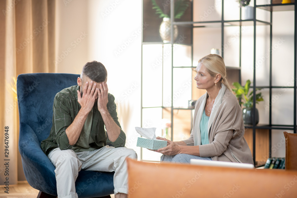 Dark-haired man having tears while reminding stressful moments Dark-haired man having tears while reminding stressful moments