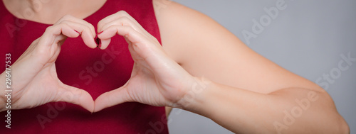 Obraz na płótnie Banner of a beautiful female's hands gesture in heart shape showing love and kindness