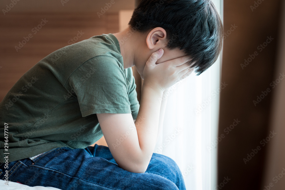 Cyber bullying and Depression. Asian preteen / teenager boy sitting alone  on the bed hands covered face. Crying, sad, depressed, stressed, frustrated  and overwhelmed. Teenager mental health problems. Stock Photo | Adobe Stock