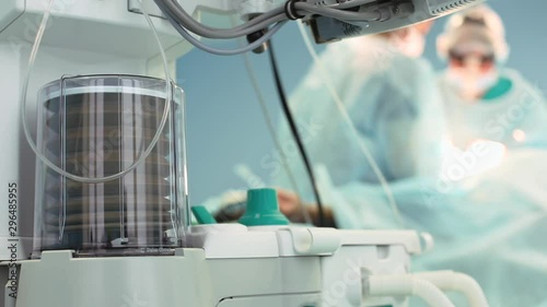 Close up view of anaesthesia machine ventilator and patients monitor inside the operating room. Close-up, blurred background, blue light.