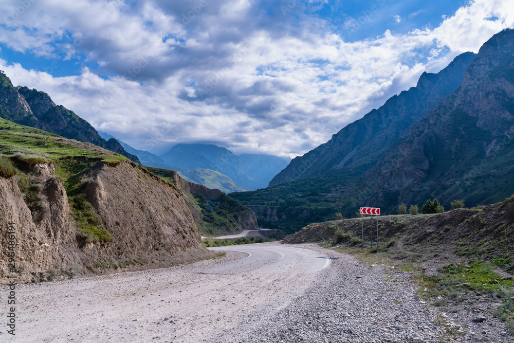 beautiful landscape winding road in mountain gorge with cloudy sky beautiful landscape winding road in mountain gorge with cloudy sky