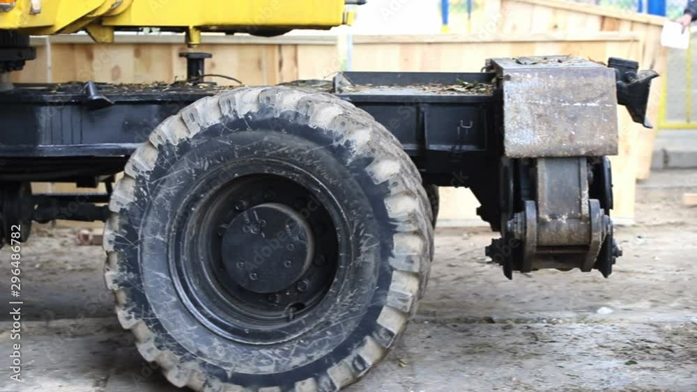 Close-up excavator wheel riding through construction site Close-up excavator wheel riding through construction site