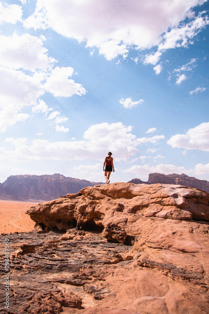 A girl walking through the rocky mountains of the desert