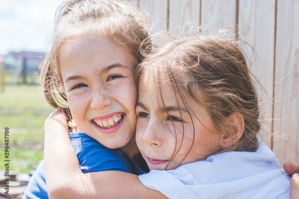 Fototapeta premium Tender sincere hugs of sisters. Family relationships.