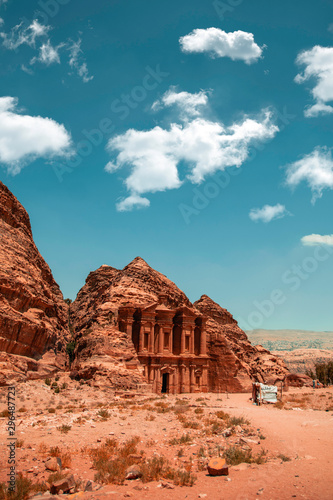 A couple of clouds floating high above the monastry in Petra, Jordan.