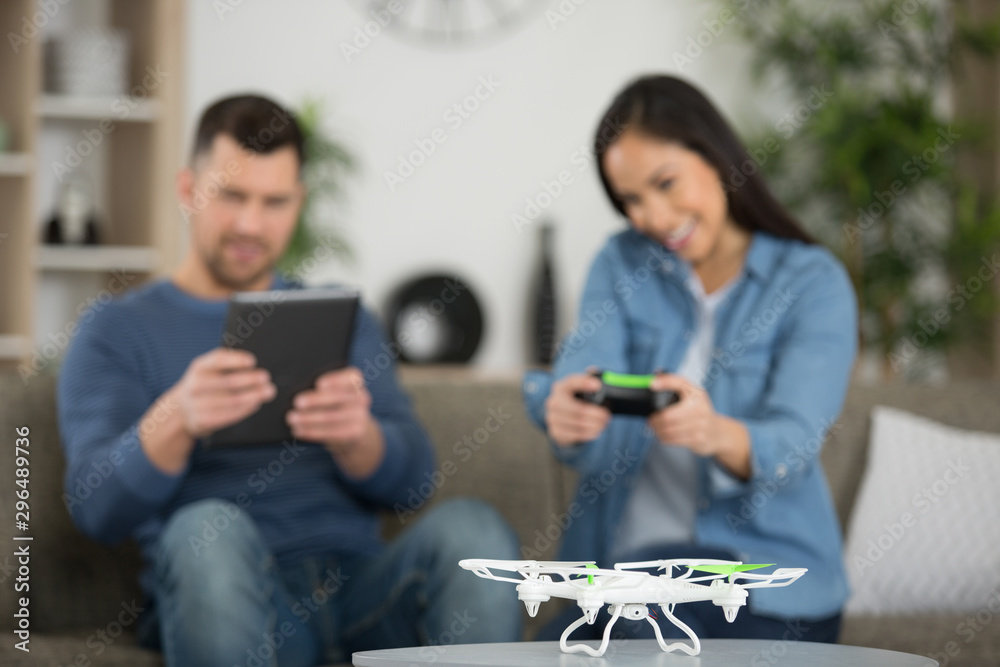 couple playing with a small quadrocopter drone couple playing with a small quadrocopter drone