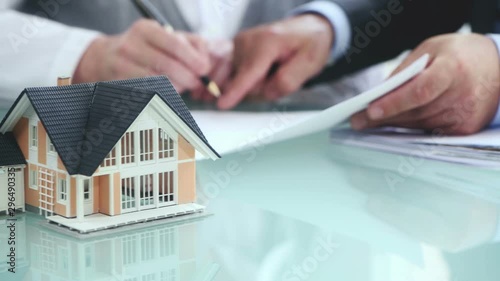 Estate agent shaking hands with customer after contract signature