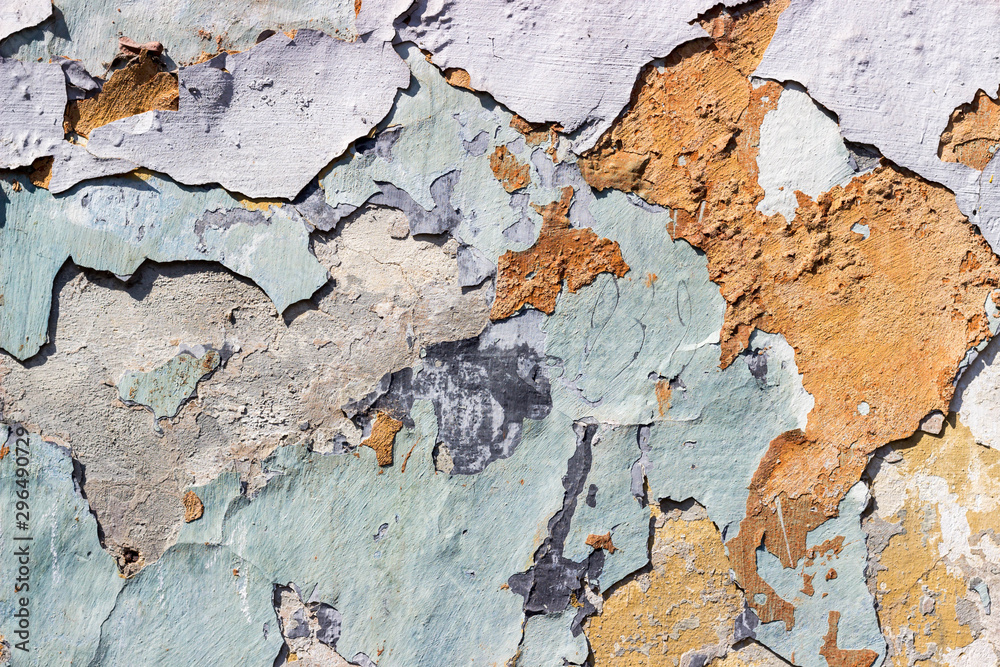 Textured wall with colorful paint, parts falling away from old age. Painted concrete wall. Grunge Textured wall with colorful paint, parts falling away from old age. Painted concrete wall. Grunge