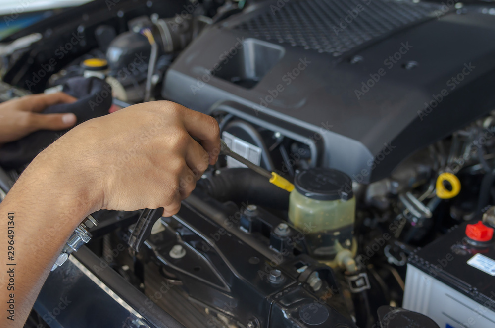 checks and cleans the car's engine. checks and cleans the car's engine.