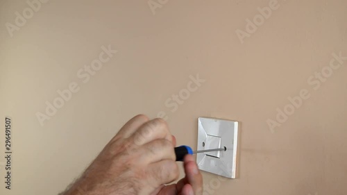 Detaching light switch from a wall with a screwdriver